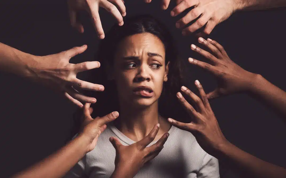 Lady looking frustrated with many hands surrounding her